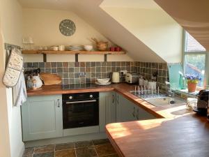 a kitchen with a sink and a counter top at Larkhams Loft in Teffont Magna +9 photos