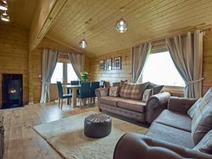 a living room with a couch and a table at Stag Lodge - Uk46921 in Falkirk