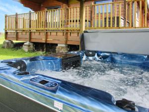 a hot tub with water in the back of a truck at Stag Lodge - Uk46921 in Falkirk +9 photos