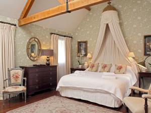 a bedroom with a white bed with a canopy at Cope - Ukc1145 in Bruern +15 photos