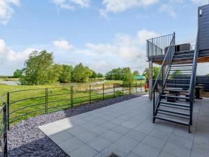 an outdoor patio with a staircase and a fence at Home Farm Lodges in Baston