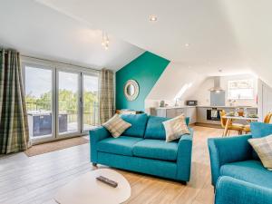 a living room with a couch and a table at Home Farm Lodges in Baston