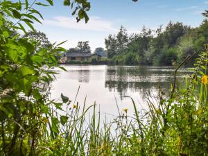 a view of a lake with a house in the distance at Stillwater in Rockland Saint Peter