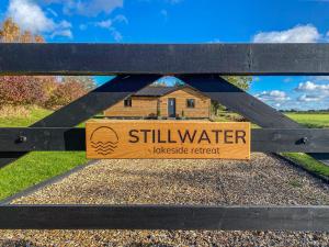 a wooden sign on a gate in front of a house at Stillwater in Rockland Saint Peter