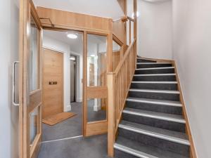 a staircase in a house with a glass door at Forest Acorn in Brockenhurst