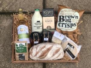 a basket filled with bread and other food items at Forest Acorn in Brockenhurst