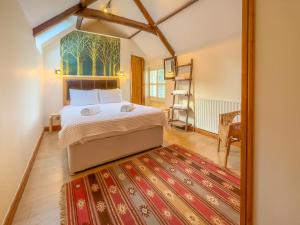 a bedroom with a bed and a mirror at Old Hall Cottage No 1 in Byers Green +2 photos