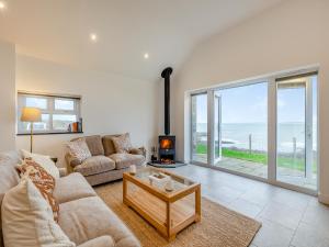 a living room with a couch and a fireplace at Y Beudy Gwydir in Trevor