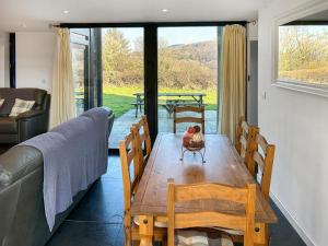 a living room with a wooden table and a couch at Y Stabl in Llangadog