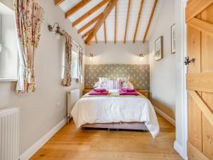 a bedroom with a bed and a wooden floor at The Lilac-Uk47149 in Burgh le Marsh +7 photos