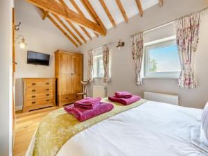 a bedroom with a bed with two towels on it at The Lilac-Uk47149 in Burgh le Marsh
