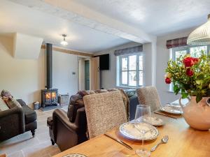 a living room with a table and a fireplace at Queens Barn in Wortham +30 photos