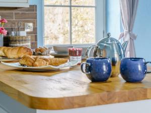 a table with croissants and croissants on it at The Cowshed - Uk32570 in Marloes +22 photos