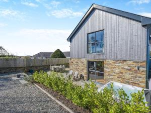 a house with a garden and a patio at Gwithian House in Port Isaac