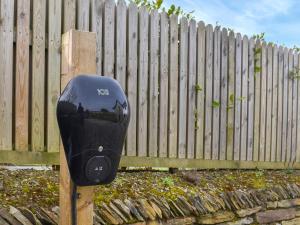 a parking meter sitting in front of a fence at Gwithian House in Port Isaac