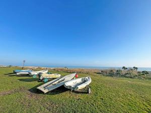 a group of kayaks sitting in a field near the ocean at Gwithian House in Port Isaac +26 photos