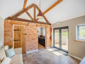an open living room with a brick wall at The Old Stables 2 - Uk46683 in Shipton under Wychwood