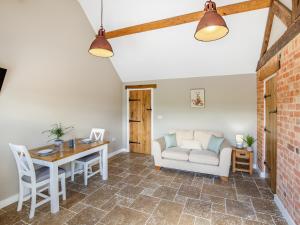 a living room with a table and a couch at The Old Stables 2 - Uk46683 in Shipton under Wychwood