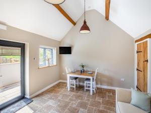 a dining room with a table and chairs at The Old Stables 2 - Uk46683 in Shipton under Wychwood +5 photos