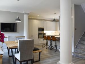 a kitchen and dining room with a table and chairs at The House At One Warwick Park in Royal Tunbridge Wells