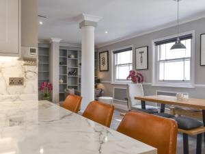 a kitchen and dining room with a table and chairs at The House At One Warwick Park in Royal Tunbridge Wells