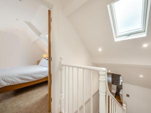 a white room with a crib and a window at Beachey View - Uk43058 in Saundersfoot