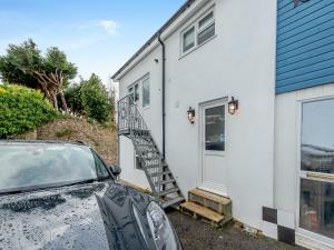 a car parked in front of a white house at Beachey View - Uk43058 in Saundersfoot +29 photos