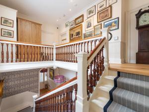 a staircase in a home with a clock on the wall at But N' Ben - Uk7560 in Inverness