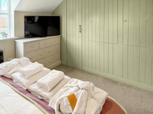 a bedroom with a bed with white towels on it at The Helmsley Retreat in Helmsley +12 photos