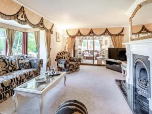 a living room with a couch and a fireplace at The Hawthorns in Ottringham
