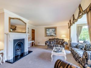 a living room with a couch and a fireplace at The Hawthorns in Ottringham