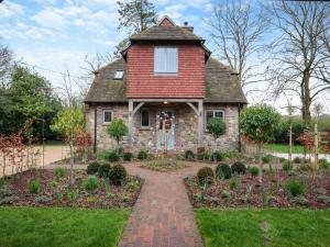 an old house with a garden in front of it at Keeds Cottage in Pulborough