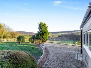 a gravel road next to a house with a fence at The Lodge in Wonastow +27 photos