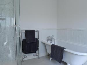 a bathroom with a tub and a sink and a shower at Yonderton Mcgill Cottage - Uk11182 in Hollybush +8 photos