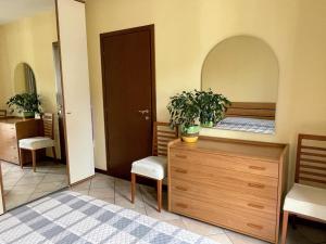 a room with a bed and a dresser with a plant on it at VerdeLago casa vacanze in Luino