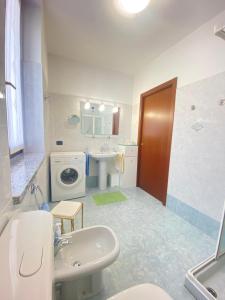 a bathroom with a sink and a washing machine at VerdeLago casa vacanze in Luino