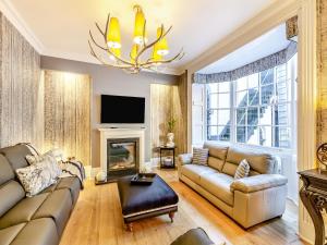 a living room with a couch and a fireplace at No3 On The Severn in Bridgnorth