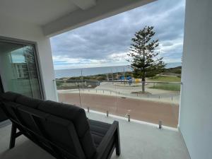 a living room with a couch and a view of the ocean at Coastal Calm Seascapes unit 3 in Falcon