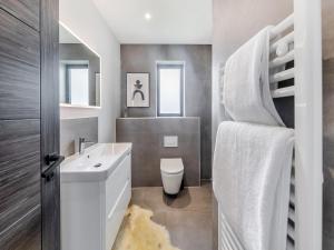 a bathroom with a white sink and a toilet at Cybi Lodge 6 - Uk42798 in Llangefni +4 photos