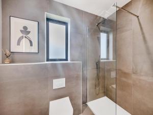 a bathroom with a shower with a glass door at Cybi Lodge 6 - Uk42798 in Llangefni