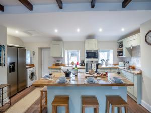 a kitchen with a large wooden table and chairs at The Old Cottage - Uk49169 in Beadnell