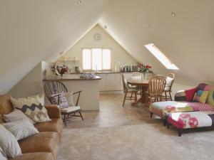 a living room with a couch and a table at Forest Cottage in Northwold