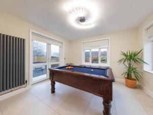 a large room with a pool table in it at Bryndedwydd in Borth