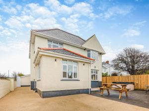 a house with a picnic table in front of it at Bryndedwydd in Borth