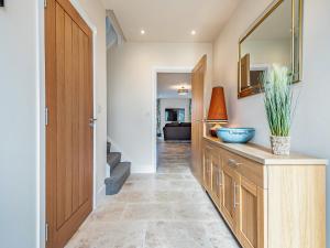a kitchen with a wooden cabinet and a mirror at Old Barn 2 - Uk48478 in Ferndown +19 photos
