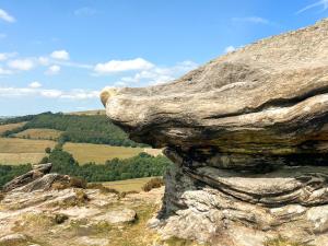 a rock on the side of a mountain at Bank Cottage in Grindleford Bridge