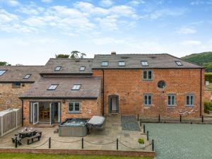 a brick house with a patio in front of it at Ty Felin - Uk12744 in Acrefair