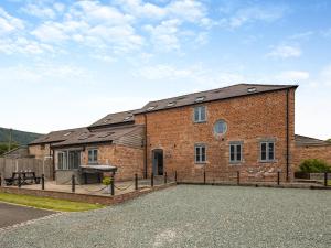 a brick building with a picnic table in front of it at Ty Felin - Uk12744 in Acrefair