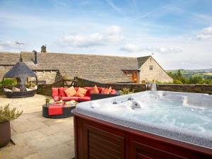 a hot tub on the patio of a house at Bramble Cottage - Uk4186 in Hazlehead Bridge +11 photos