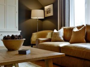 a living room with a couch and a coffee table at Darroch View in Ballater